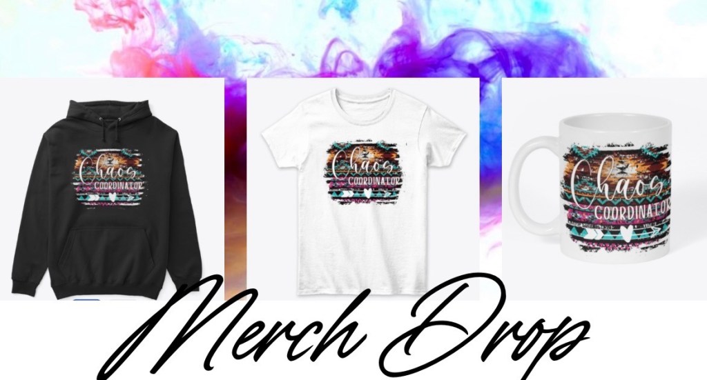 A stylish woman wearing a black Chaos Coordinator t-shirt, standing confidently in a bright, modern workspace. Text on the shirt reads “Chaos Coordinator.” The image represents moms and leaders turning chaos into productivity and progress.